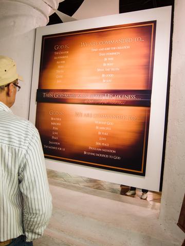 A man reading an exhibit sign