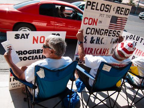 People with signs on the roadside