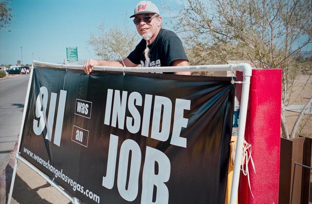 Man with sign saying 9/11 was an inside job